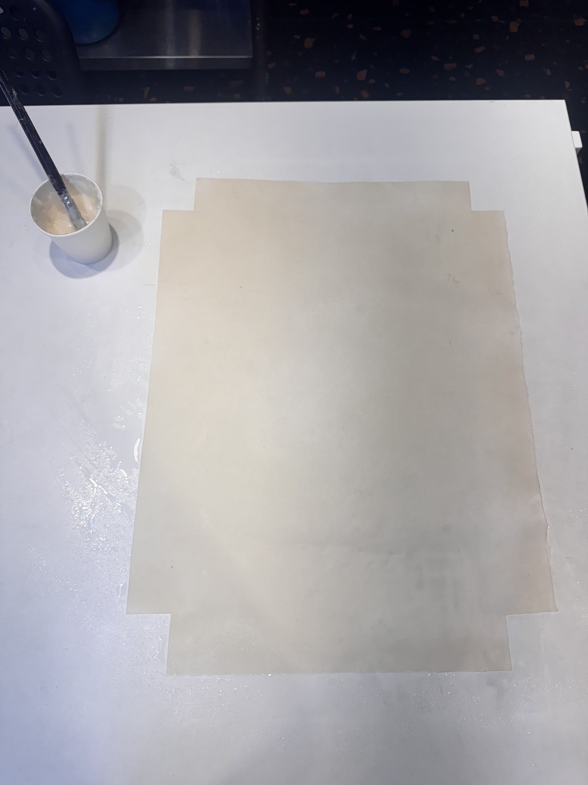 A sheet of hanji paper laid on a wooden surface.